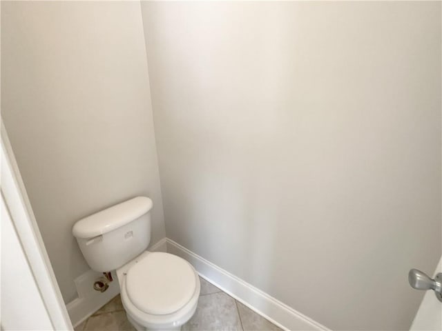 6405 Beaver Creek Trl, Atlanta, GA 30349 - bathroom with baseboards, tile patterned flooring, and toilet