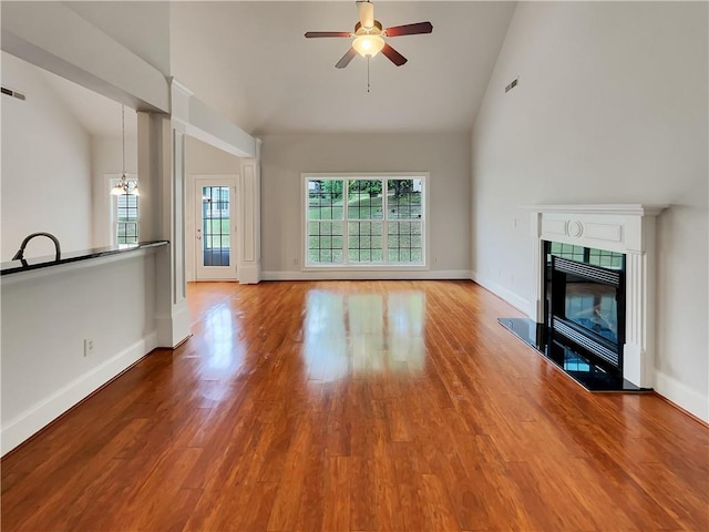 6405 Beaver Creek Trl, Atlanta, GA 30349 - unfurnished living room with a ceiling fan, baseboards, wood finished floors, and a tile fireplace