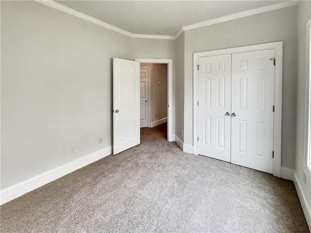 6405 Beaver Creek Trl, Atlanta, GA 30349 - unfurnished bedroom with crown molding, carpet flooring, baseboards, and a closet