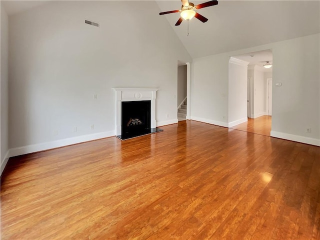 6405 Beaver Creek Trl, Atlanta, GA 30349 - unfurnished living room with ceiling fan, visible vents, light wood-type flooring, high vaulted ceiling, and baseboards