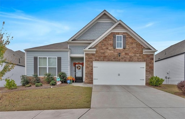 craftsman-style home with a garage and a front yard