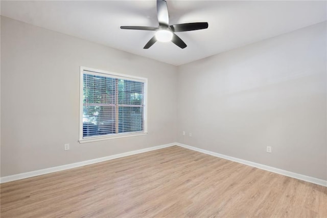 empty room with ceiling fan and light hardwood / wood-style flooring