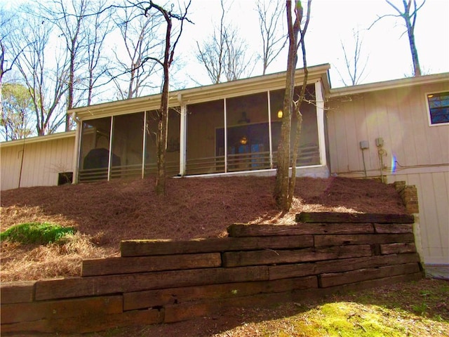 rear view of property with a sunroom