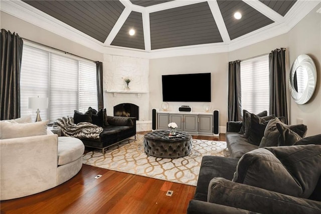 living area featuring ornamental molding, plenty of natural light, and wood finished floors