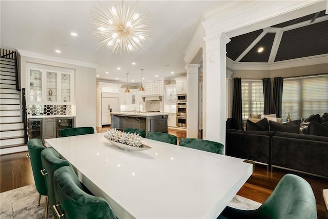 dining room with dark wood-style flooring, beverage cooler, and stairs