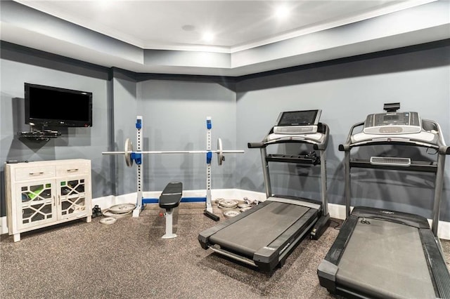 exercise room featuring baseboards and crown molding