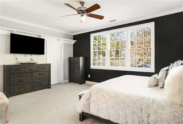 carpeted bedroom with ceiling fan, ornamental molding, visible vents, and baseboards