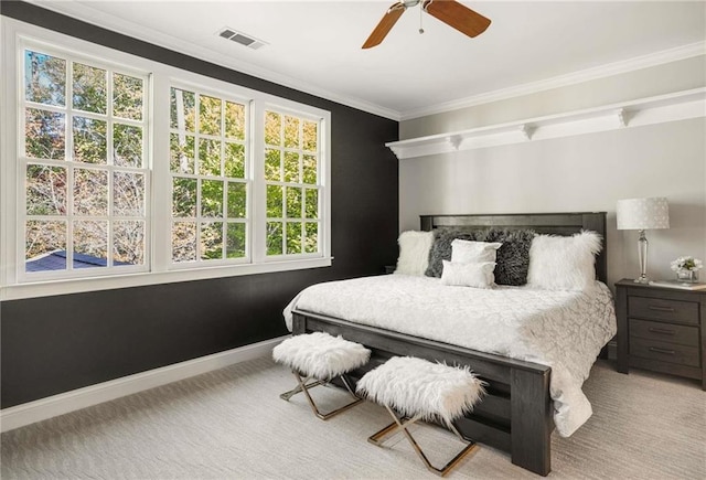 carpeted bedroom featuring baseboards, visible vents, ornamental molding, and ceiling fan