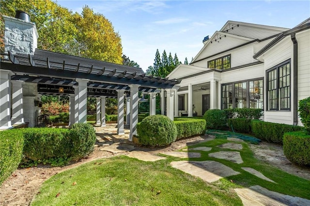 exterior space featuring a chimney and a pergola