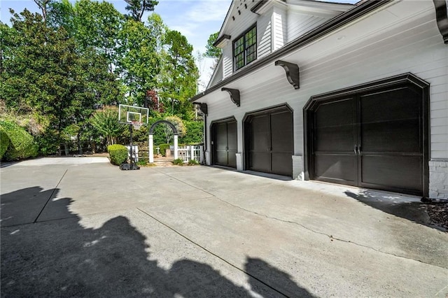 garage featuring concrete driveway