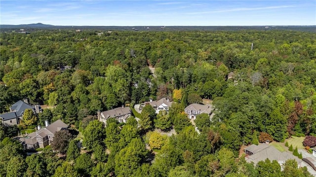 birds eye view of property featuring a forest view and a residential view