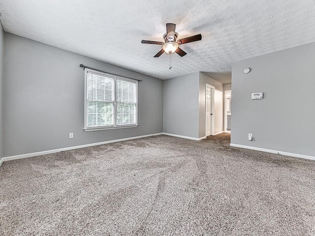 empty room with a textured ceiling, carpet floors, and ceiling fan