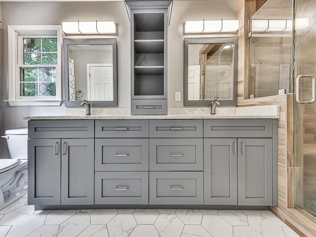 bathroom featuring vanity, toilet, and a shower with shower door