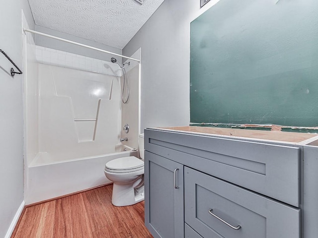 full bathroom featuring toilet, a textured ceiling, shower / tub combination, vanity, and hardwood / wood-style floors