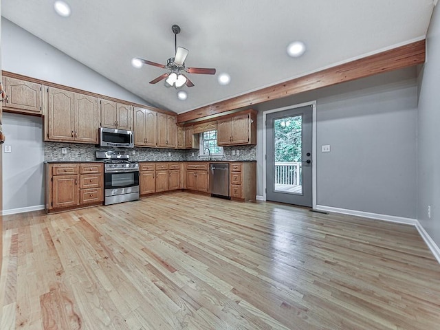 kitchen featuring ceiling fan, appliances with stainless steel finishes, tasteful backsplash, light hardwood / wood-style floors, and vaulted ceiling