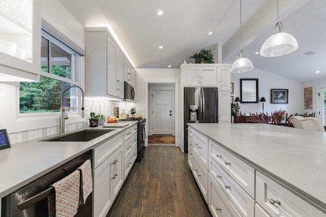 kitchen with vaulted ceiling, dark hardwood / wood-style flooring, stainless steel appliances, white cabinetry, and sink