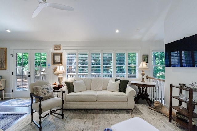 living room with hardwood / wood-style flooring, ceiling fan, a wealth of natural light, and french doors