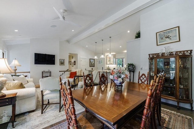 dining area with ceiling fan, vaulted ceiling with beams, and wood-type flooring