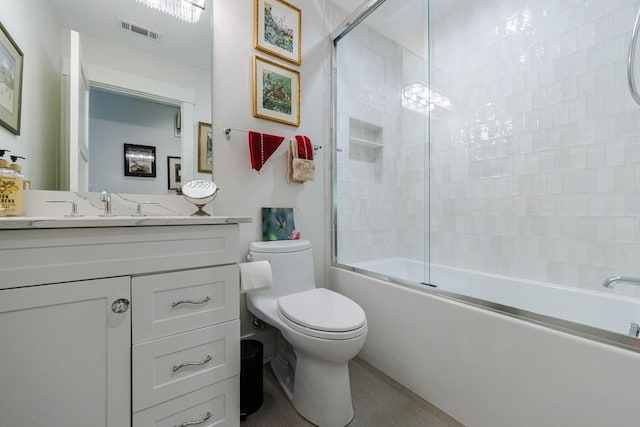 full bathroom featuring enclosed tub / shower combo, toilet, and large vanity