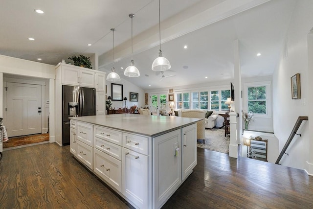 kitchen featuring white cabinetry, dark hardwood / wood-style flooring, a center island, and pendant lighting