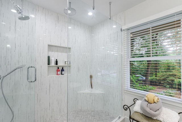 bathroom with a healthy amount of sunlight and a shower with shower door