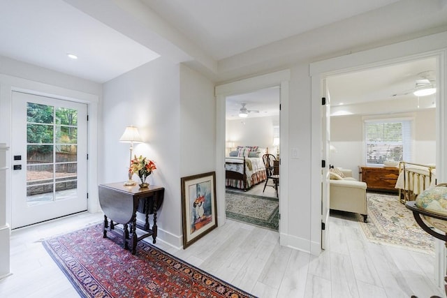 interior space featuring light wood-type flooring, plenty of natural light, and ceiling fan