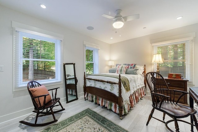 bedroom with ceiling fan and light hardwood / wood-style flooring