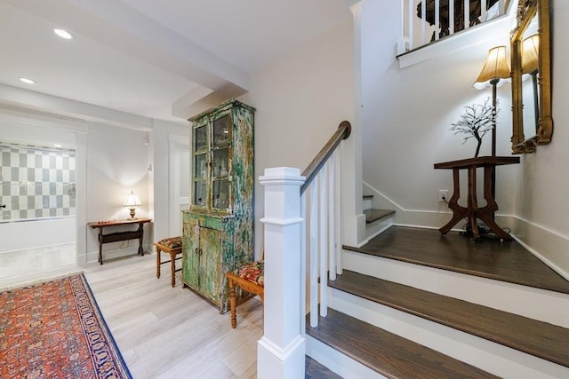 staircase with light wood-type flooring