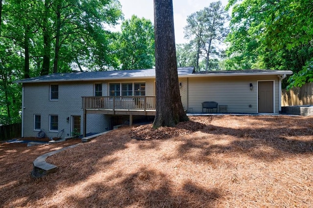 rear view of house featuring a deck