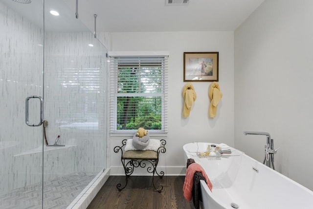 bathroom with a shower with shower door and hardwood / wood-style flooring