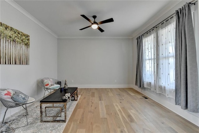 unfurnished room featuring hardwood / wood-style flooring, ceiling fan, and crown molding