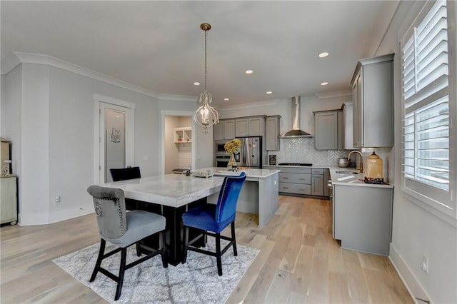 dining area with crown molding, sink, and light hardwood / wood-style flooring