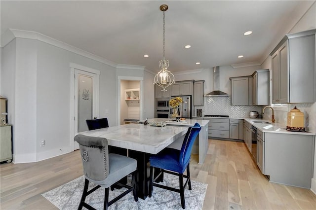 dining space featuring ornamental molding, sink, and light wood-type flooring