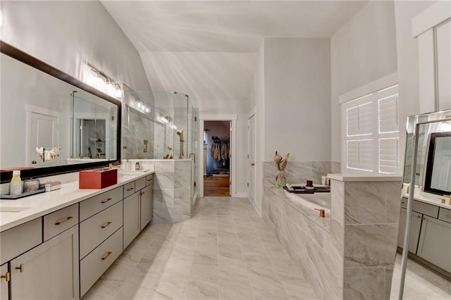 bathroom featuring independent shower and bath and vanity