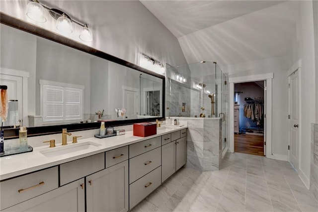 bathroom with walk in shower, vanity, and vaulted ceiling