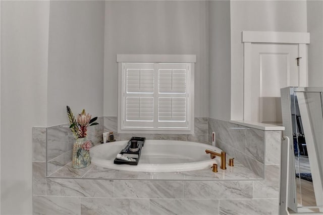 bathroom featuring tiled bath