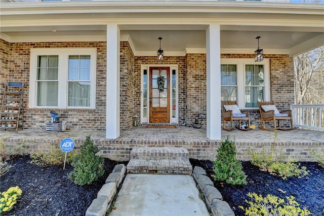 view of exterior entry featuring a porch