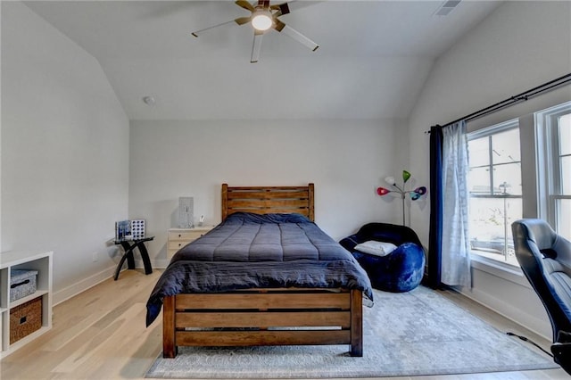 bedroom featuring ceiling fan, vaulted ceiling, and light hardwood / wood-style flooring