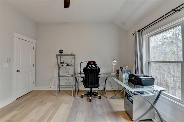 home office with lofted ceiling, a wealth of natural light, and light wood-type flooring