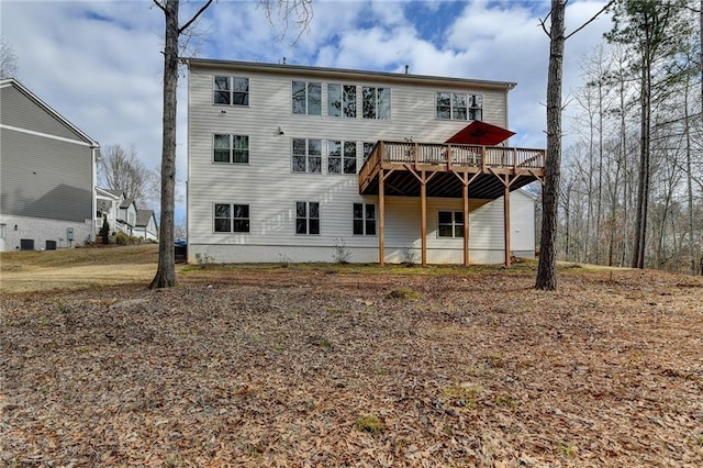 back of house with a wooden deck