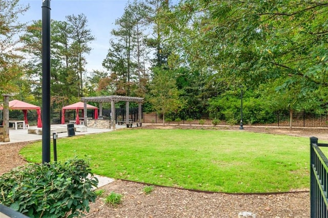 view of yard featuring fence, a pergola, and a gazebo