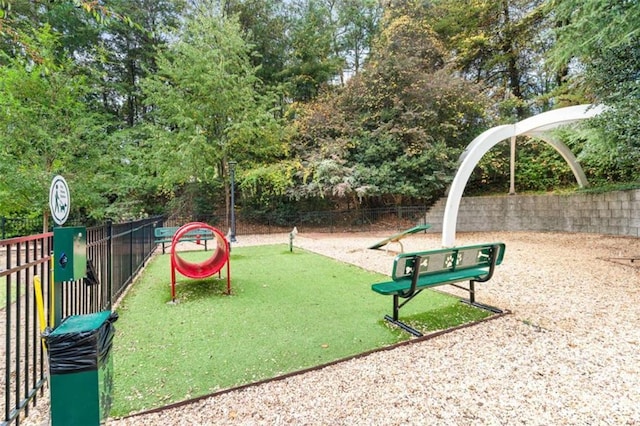 view of jungle gym featuring fence