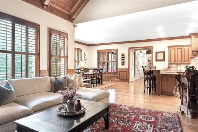 13037 Overlook Pass, Roswell, GA 30075 - living area featuring plenty of natural light, wainscoting, light wood finished floors, and ornamental molding