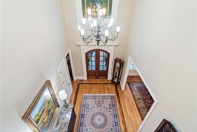 13037 Overlook Pass, Roswell, GA 30075 - entryway with a chandelier, wood finished floors, a high ceiling, and french doors