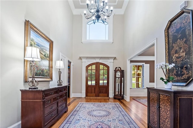 13037 Overlook Pass, Roswell, GA 30075 - foyer entrance with light wood-type flooring, a chandelier, a towering ceiling, crown molding, and french doors