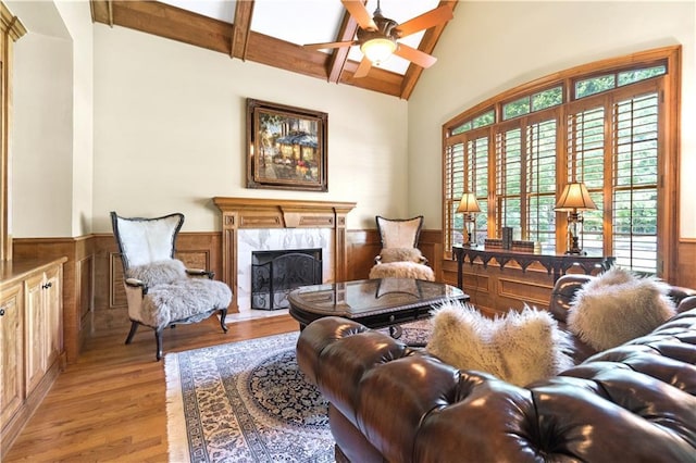 13037 Overlook Pass, Roswell, GA 30075 - living room featuring a wainscoted wall, beam ceiling, wood finished floors, a high end fireplace, and ceiling fan