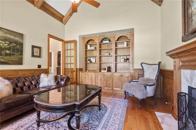 13037 Overlook Pass, Roswell, GA 30075 - living room featuring high vaulted ceiling, a wainscoted wall, wood finished floors, a ceiling fan, and wood walls
