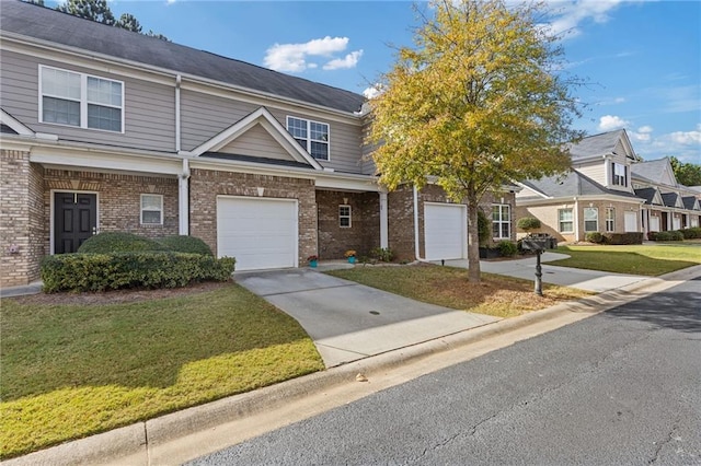 multi unit property with a garage and a front yard