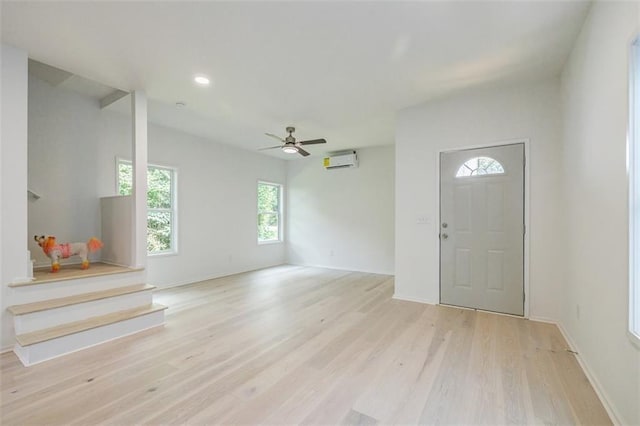 entryway featuring an AC wall unit, wood finished floors, recessed lighting, baseboards, and ceiling fan