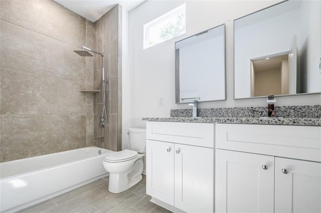 full bathroom with double vanity, toilet, a sink, and shower / tub combination